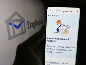 Stuttgart, Germany, 05-21-2024: Person holding smartphone with webpage of German non-governmental