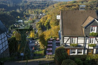 Autumn landscape with a view of a cable car and traditional village architecture, Burg Castle in