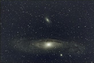 An impressive close-up of a large spiral galaxy (M 31, Andromeda Nebula) surrounded by countless