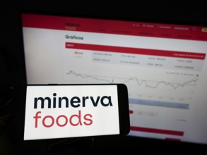 Stuttgart, Germany, 03-30-2022: Person holding mobile phone with logo of Brazilian foods company