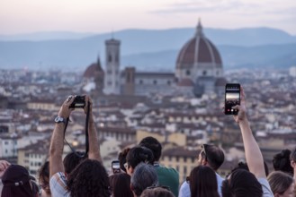 FLORENCE, ITALY, SEPTEMBER 21, 2023, Large tourist crowd on Piazzale Michelangelo enjoying sunset