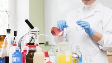 Close up scientist holding flask