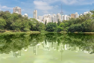 Sao Paulo, Brazil, October 15 2016: The buldings and forest reflection over the lake at the