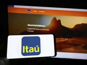 Stuttgart, Germany, 10-14-2022: Person holding cellphone with logo of Brazilian company Itau