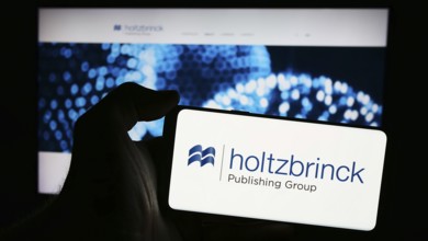 Stuttgart, Germany, 05-22-2024: Person holding mobile phone with logo of German media company