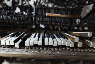 Detail of broken grand piano in mess hall of abandoned military base in Chernobyl Exclusion Zone of