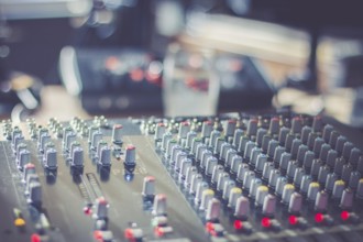 Professional music production in a sound recording studio, mixer desk
