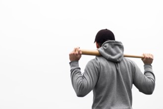 Back view man holding baseball bat shoulders