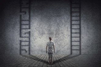 Person stands in front of a wall casting two ladder shadows with one broken on the left and another
