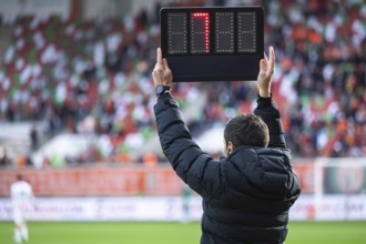 Technical referee shows added time during football match