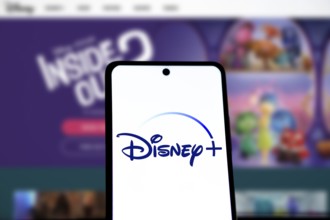Smartphone with Disney+ logo displayed on the screen.