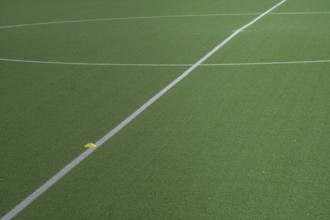 Partial image of green artificial turf in sports stadium