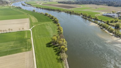 Greened bank areas with neighbouring fields and a meandering river (Danube) in a rural landscape,