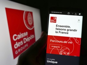 Stuttgart, Germany, 03-12-2023: Person holding smartphone with webpage of Caisse des Depots et