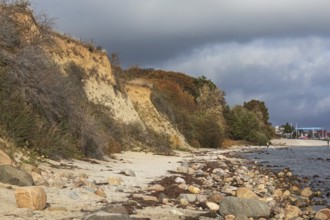 Baltic Sea beach with rocks and cliffs in autumn near Grömitz, Schleswig-Holstein. With dark clouds