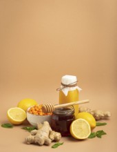 Composition with detox drink, sea buckthorn berries, lemons, mint, ginger, honey in glass jar. Food