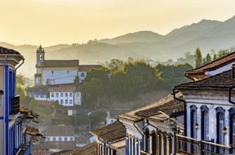 Facades of houses and church in colonial architecture in an old street in the city of Ouro Preto