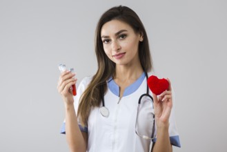 Beautiful woman holding plush heart blood sample
