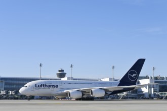 Lufthansa Airbus A380-800 with control tower, taxiing in front of Terminal 2 to runway South