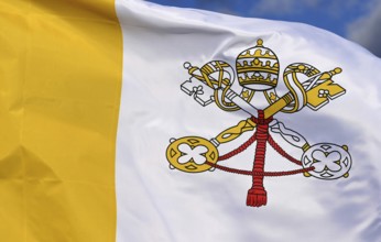 Close-up of the national flag of the Vatican State, fluttering in the wind with folds, wave