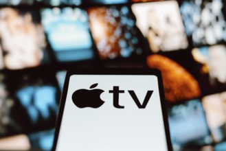 In this photo illustration, the Apple TV logo is displayed on a smartphone screen