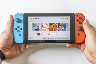 Calgary, Alberta, Canada. May 16, 2024. A person holding a Nintendo Switch