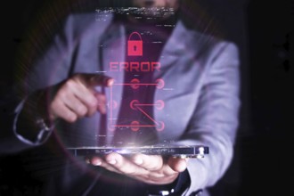 A man interacts with a virtual error message related to security on a transparent digital device.