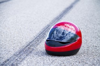 An accident with a motorbike. Traffic accident and skid marks on road Symbol photo, An accident