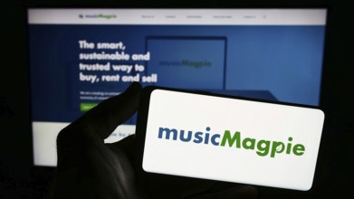 Stuttgart, Germany, 12-07-2023: Person holding smartphone with logo of British e-commerce company