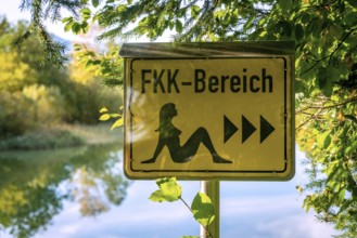 German sign board leading the way to the nude swimming area (FKK area) at the beach of lake Bibi