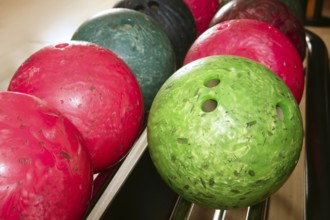 Bowling balls red green closeup row detail