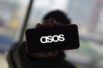 Dhaka, Bangladesh 14 Dec 2024:Cellphone with logo of British fashion retail company ASOS plc on