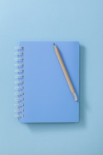 Blue Notepad With Wooden Pencil Close Up