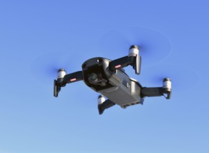 Black unmanned aerial vehicle with a camera against the blue sky