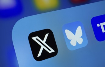 A close up of an iPad screen displaying the X, Bluesky and Truth Social app