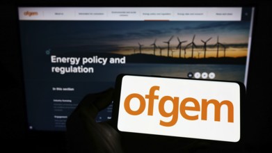 Stuttgart, Germany, 07-15-2022: Person holding mobile phone with logo of Office of Gas and