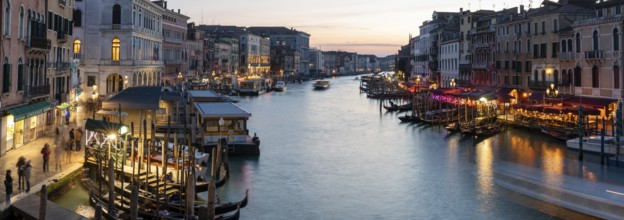Evening light at sunset, view over the Grand Canal, gondola and boats, from the Rialto Bridge,