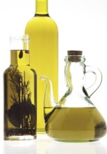 OLIVE OIL, BOTTLES AGAINST WHITE BACKGROUND
