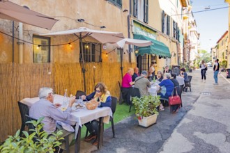Guests at the tables in front of the restaurants in Via Roma, Orbetello, Tuscany