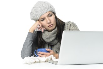 Close up Tired Sick Woman in Gray Winter Attire Working with Her Laptop While Having Cup of hot tea