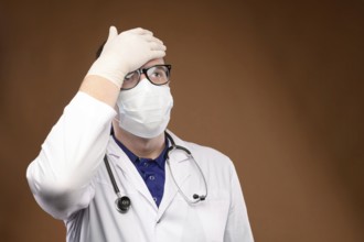 Male Caucasian doctor in white medical uniform shows face palm gesture. Chagrin and disappointment.