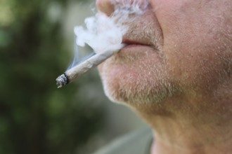 A man smokes a joint