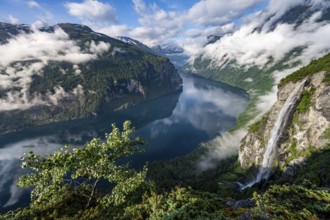 Gjerdefossen waterfall, at Ørnesvingen viewpoint, atmospheric clouds over the fjord in the morning