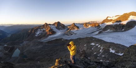 Mountaineers photographed, picturesque high mountain landscape at sunrise with alpenglow, glacier