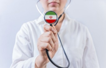 Female doctor holding stethoscope with Iran flag. National health system of Iran