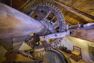 Interior view with wooden mill wheel in a rustic attic, Kefalos, Kos, Dodecanese, Greek Islands,