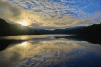 Sunbeams at sunrise over lake, landscape in morning light, summer, Rursee, Obersee, Rurberg,
