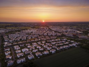 The sun rises behind the Riedberg district of Frankfurt. (Aerial photo with a drone), Germany,