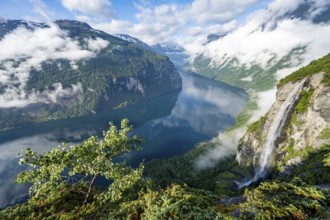 Gjerdefossen waterfall, at Ørnesvingen viewpoint, atmospheric clouds over the fjord in the morning