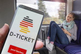 (Photomontage) Logo of the Deutschlandticket on the smartphone, in the background a young woman on